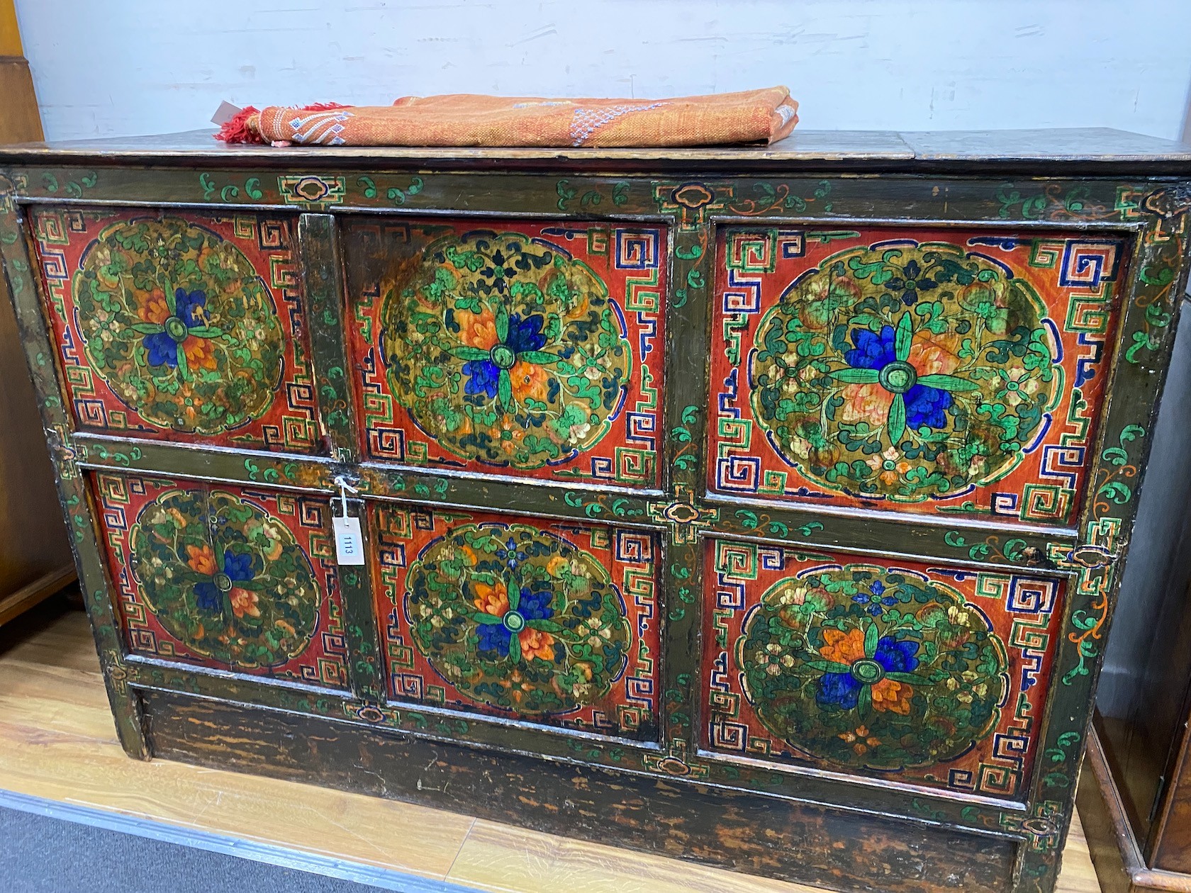 A 19th century Tibetan painted side cabinet, width 145cm, depth 52cm, height 96cm